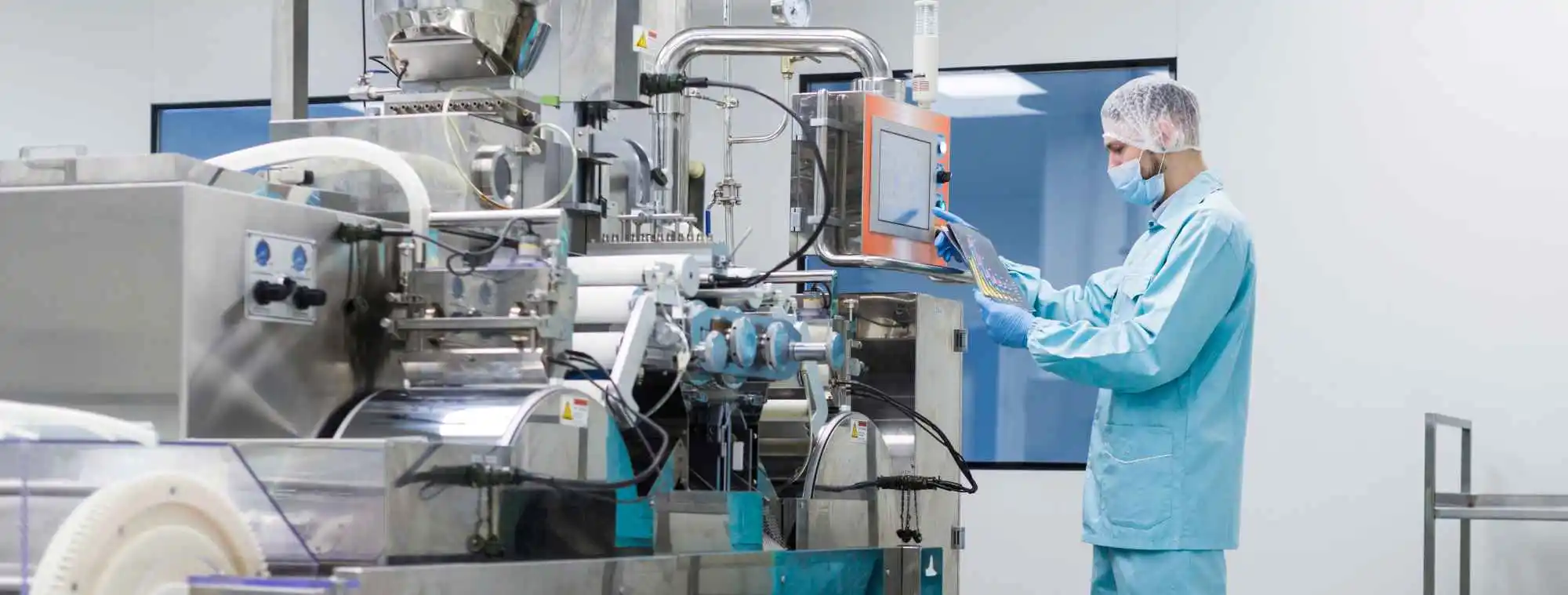 Operator working inside an isolator suite designed for high-potency compound manufacturing.